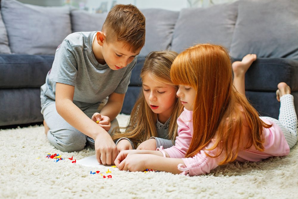 3 kids playing on floor