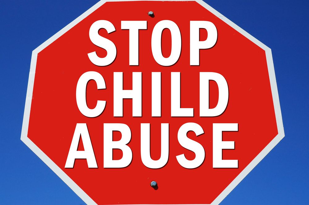 stop sign shape with words Stop Child Abuse